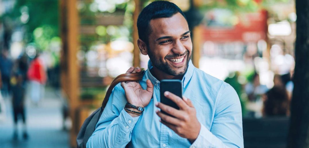 Businessman walking on city street talks about successful data management practices