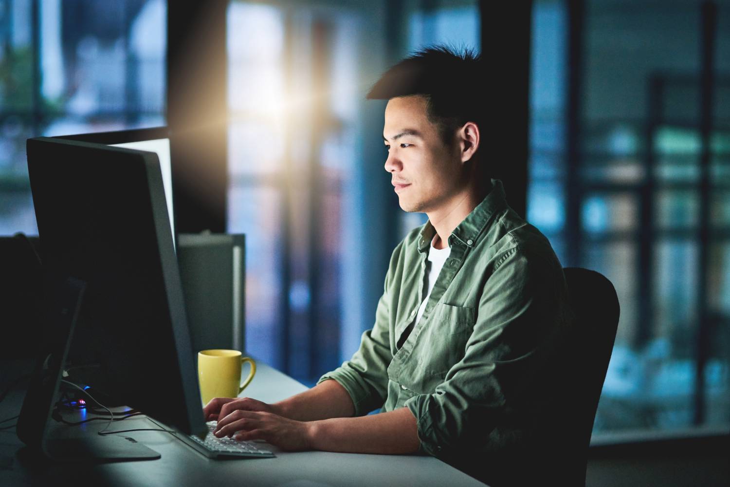 Young businessman working late to try to improve data accuracy