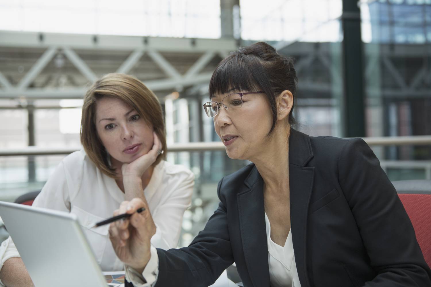 Business women discuss data tagging best practices for their organization